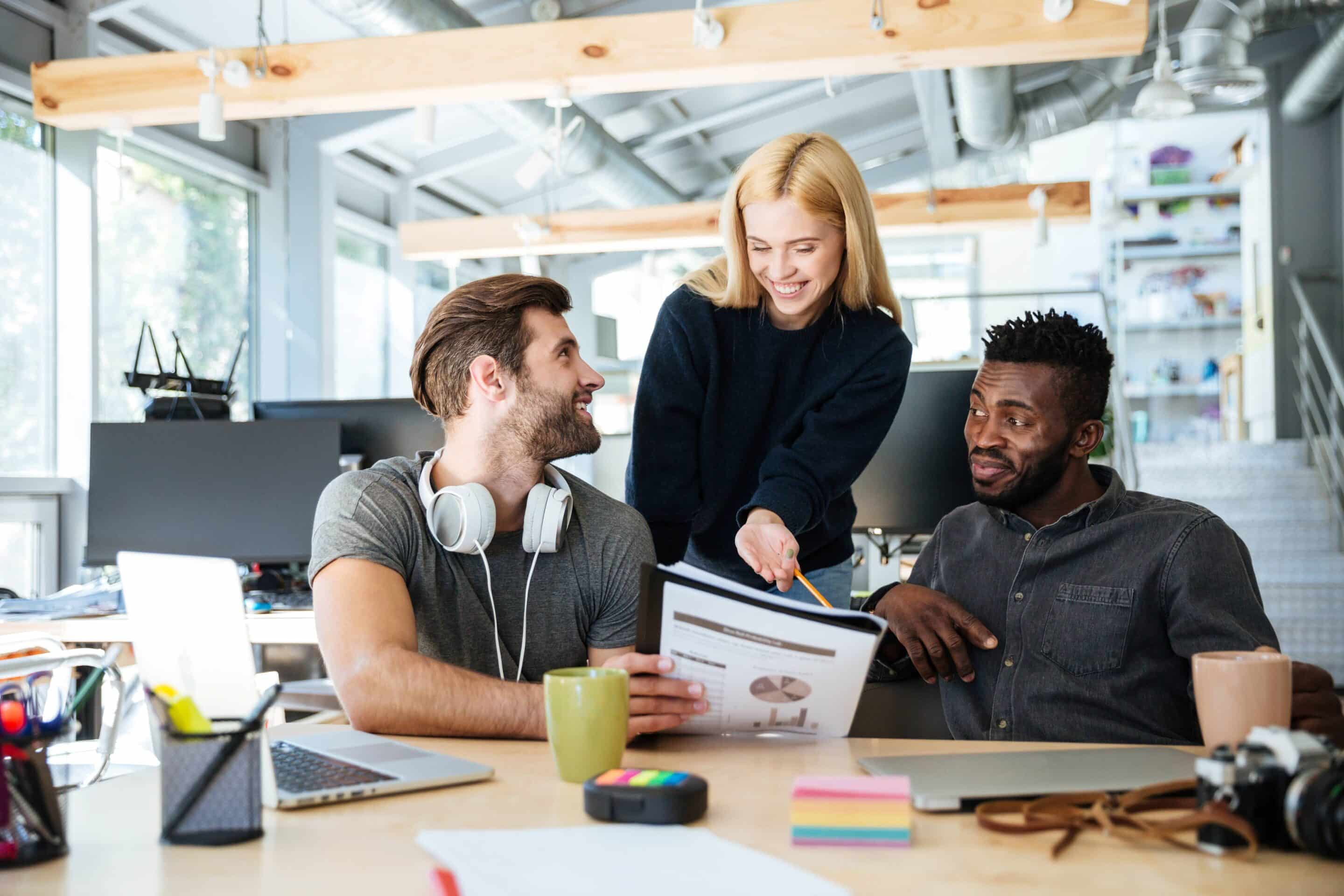 Happy young colleagues working together in a coworking office Happy young colleagues working together in a coworking office